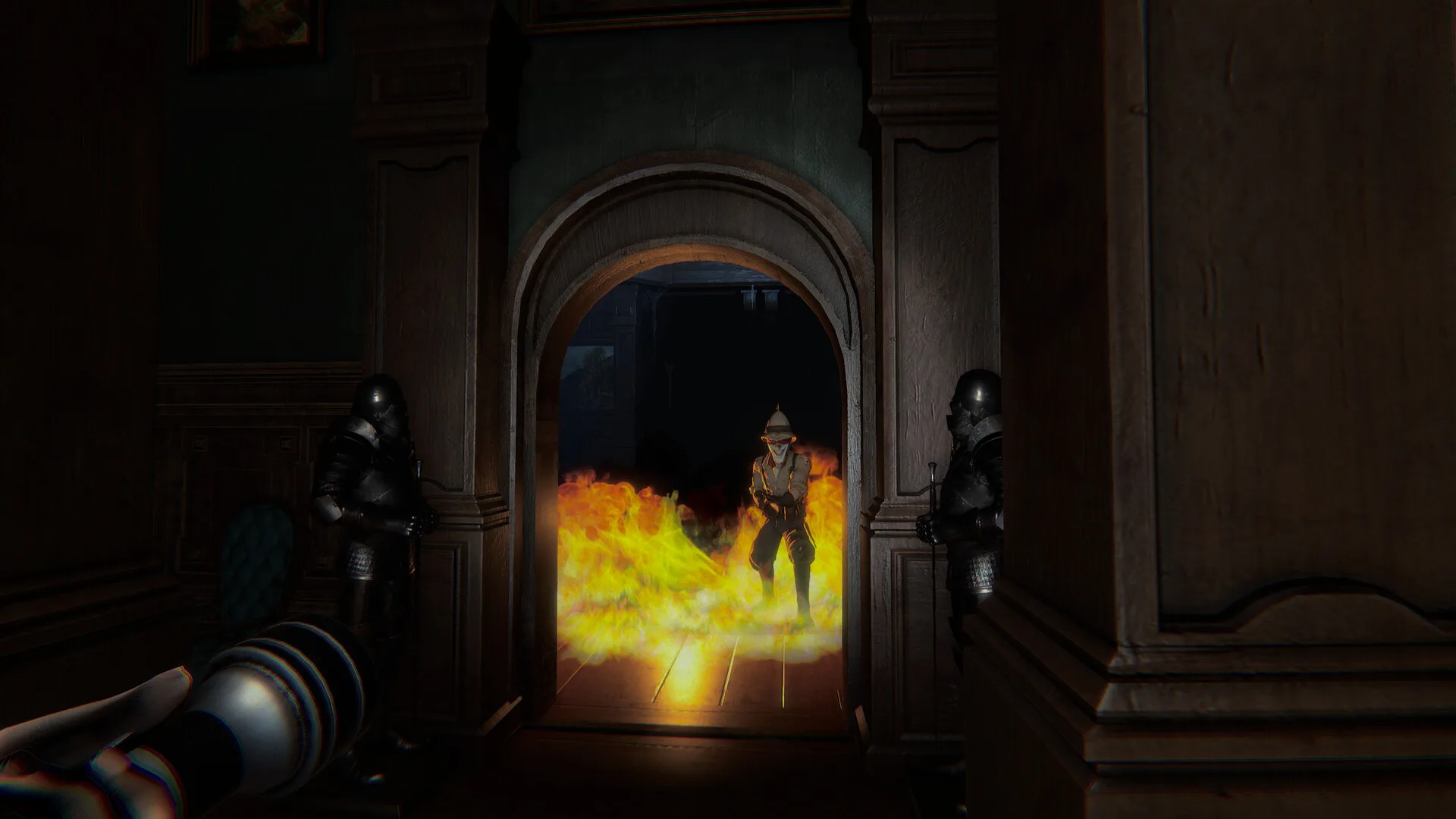 First-person Invokyr view of a spiked-helmet figure standing in flames inside a manor doorway.